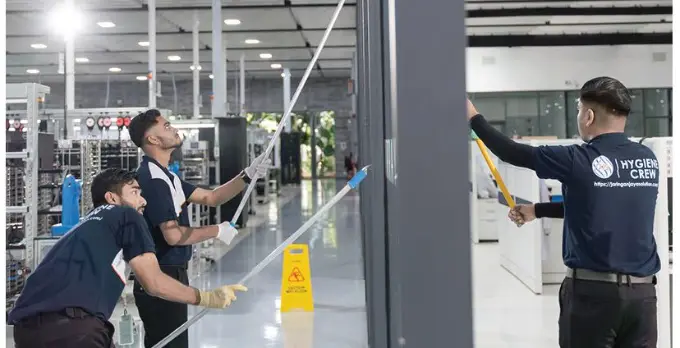 High-reach glass cleaning in a facility corridor