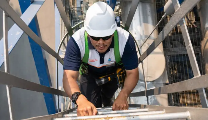 Working at height with safety harness during facility works