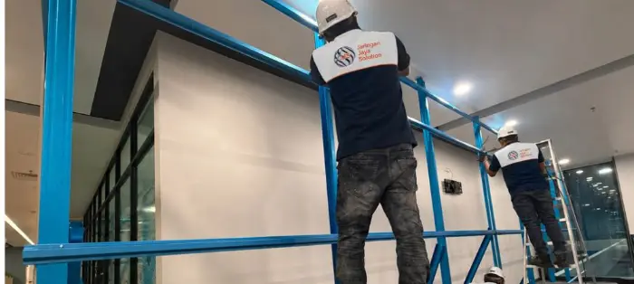 Technician on elevated access performing maintenance works
