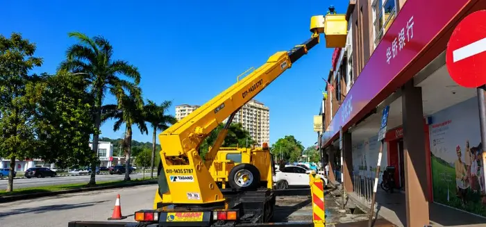 Boom lift servicing exterior signage and facade