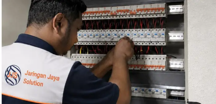 Electrical panel maintenance by uniformed technician